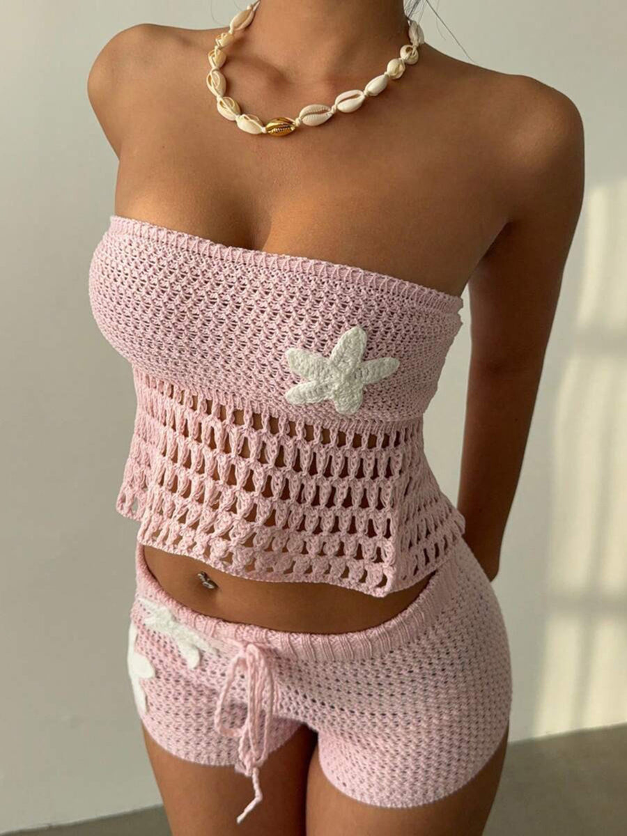 Pink crochet tube top and shorts set with white flower appliques and drawstring waist.