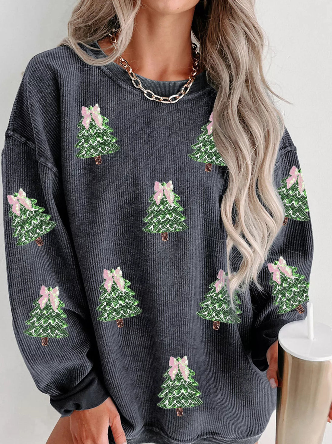 Dark gray corduroy sweatshirt with all-over sequin Christmas trees and pink bows.