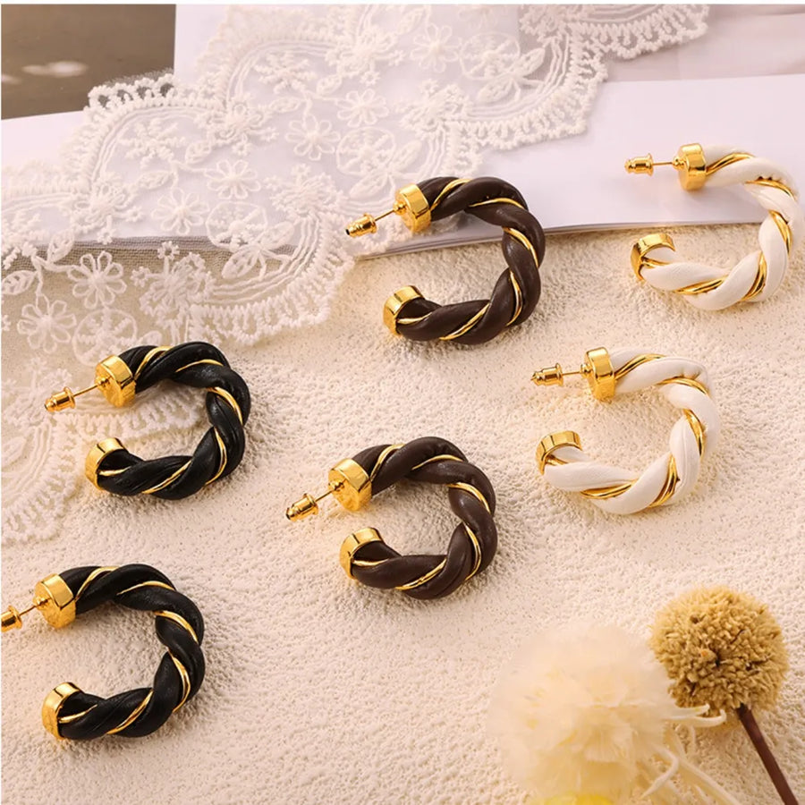 Braided leather hoop earrings with gold accents in black, coffee brown, and white.