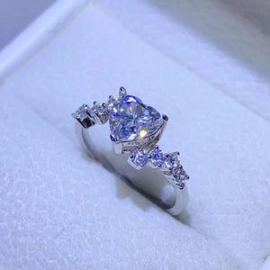 Silver ring with a heart-cut diamond cluster and accent stones.