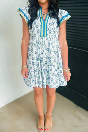 Floral cotton blend dress with notched neckline, cap sleeves, and blue floral print.
