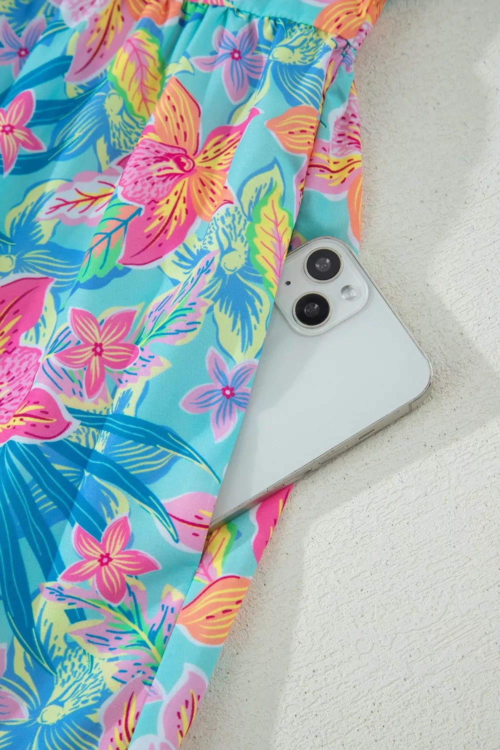 Tropical floral print dress with pocket detail and scalloped trim.