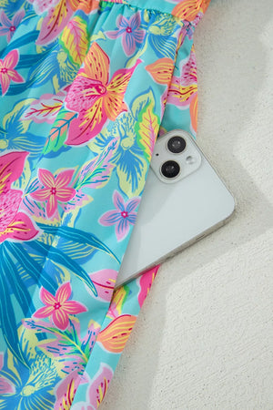 Tropical floral print dress with pocket detail and scalloped trim.