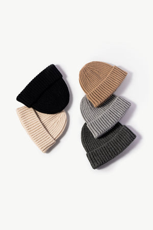 Chunky ribbed knit beanies in black, cream, brown, gray, and dark gray.