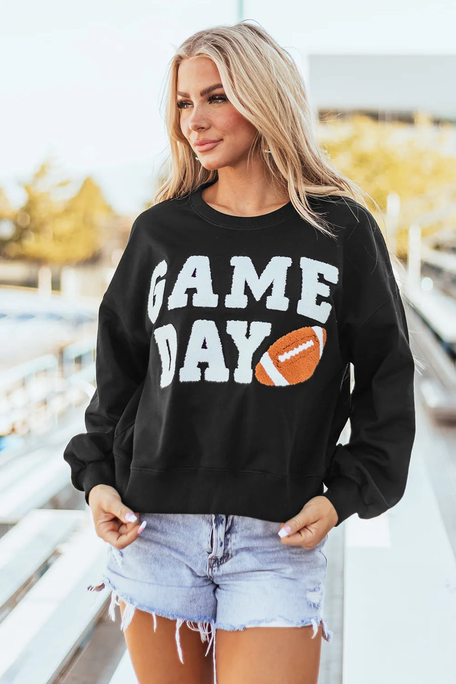 Black sweatshirt with white GAME DAY graphic and football applique.