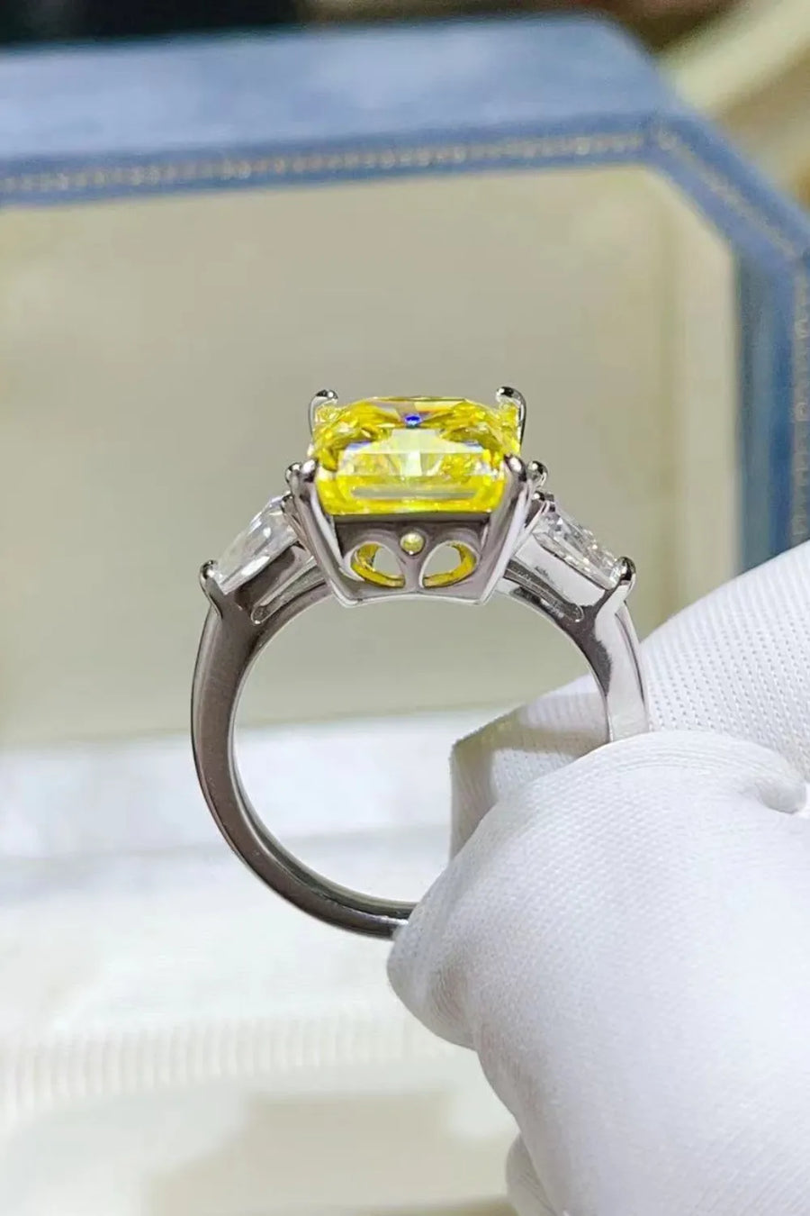 Canary yellow emerald cut ring with side stones on a silver band