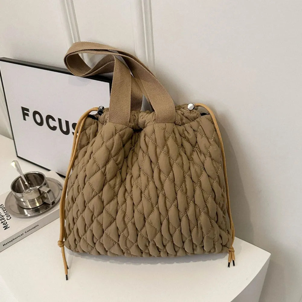 Quilted drawstring carryall handbag in Khaki with diamond pattern and dual straps.
