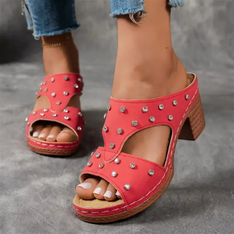 Red studded cutout platform mule sandals with a block heel.