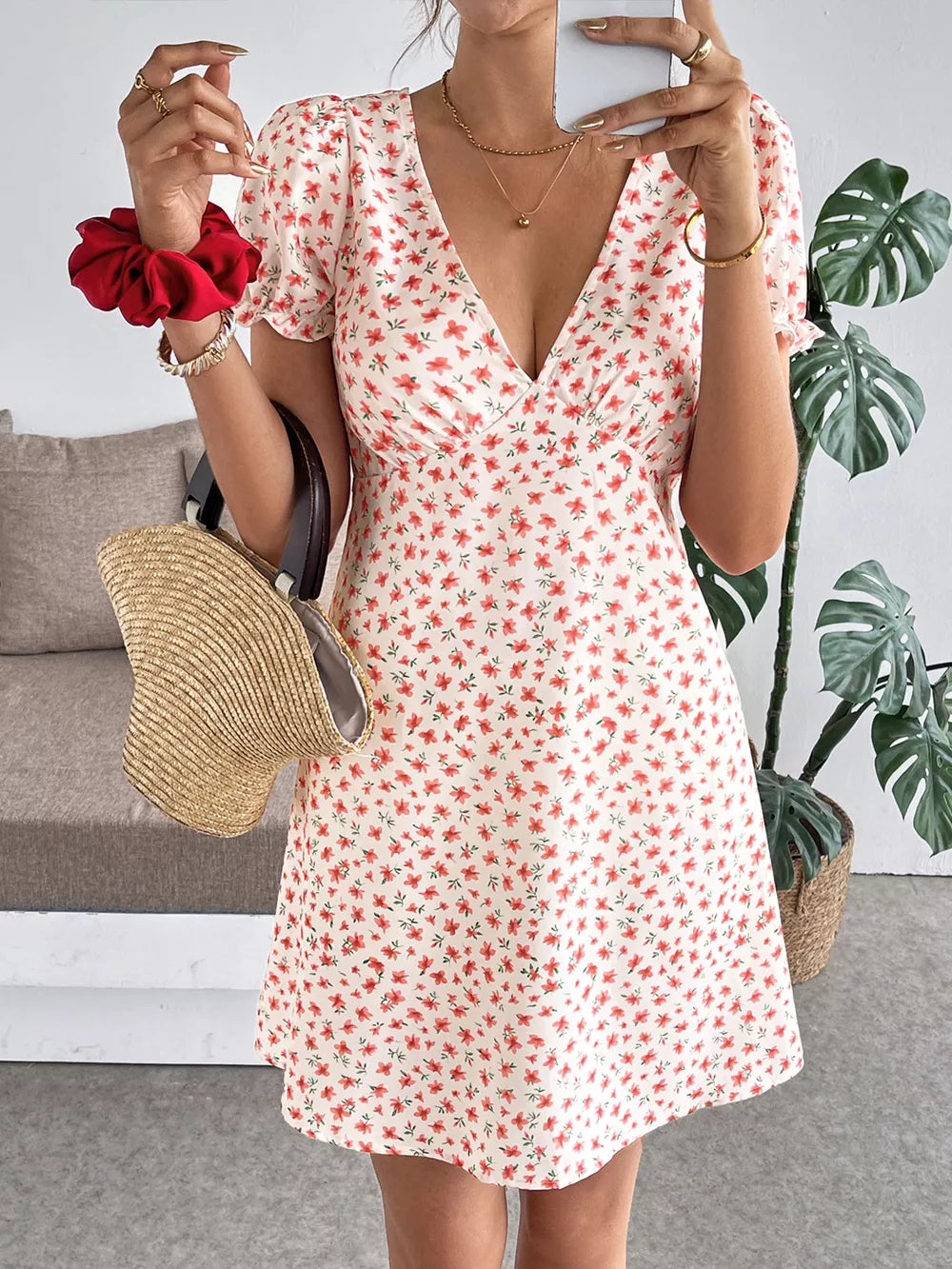 Floral V-neck puff sleeve mini dress with red floral print on white fabric.