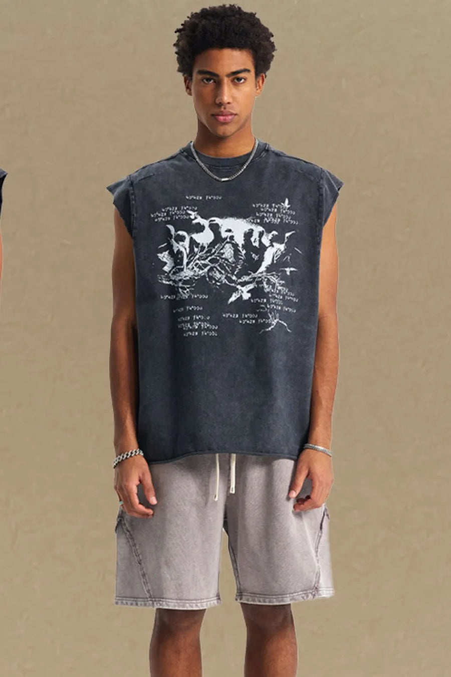 Black washed graphic sleeveless tee with raw edges and a distressed print.