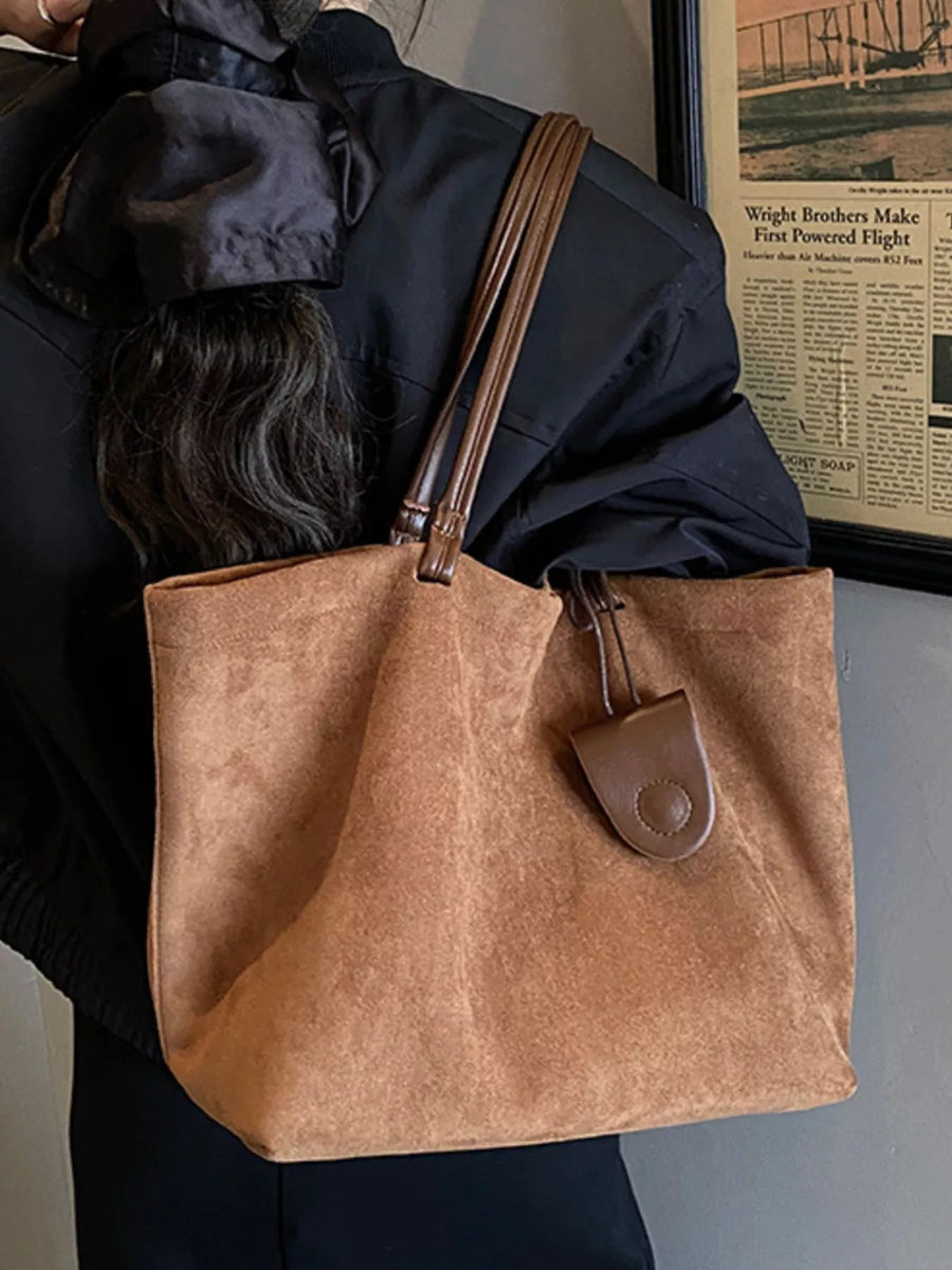 Large caramel brown suede tote bag with leather straps and a matching fob.