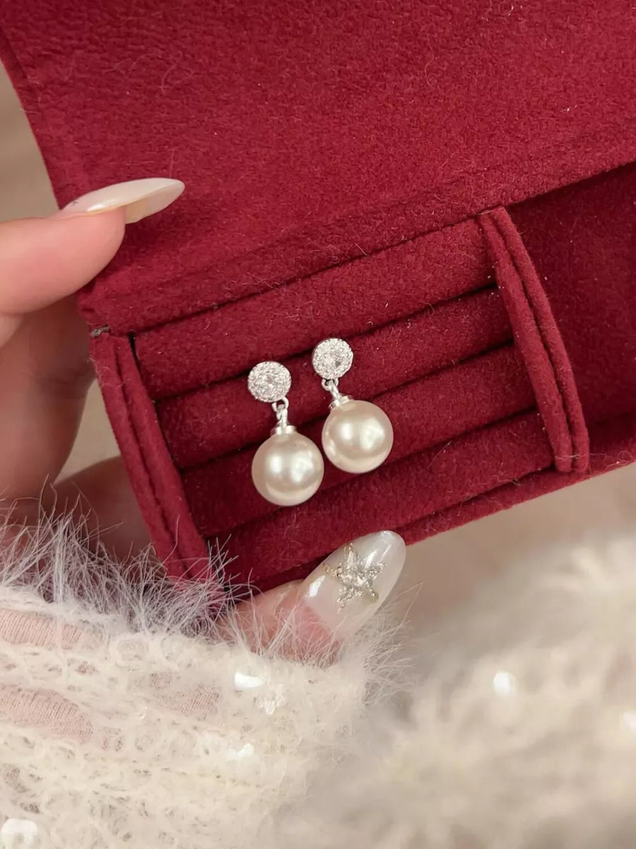 Lustrous pearl drop earrings with zircon accents on 925 silver.