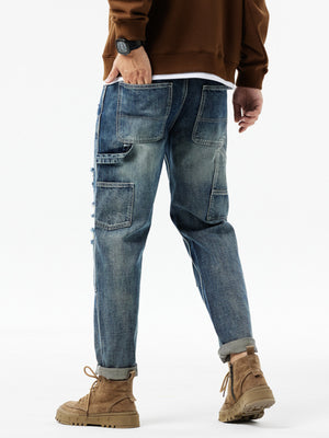 Men's distressed blue denim jeans with utility loop and multiple pockets.