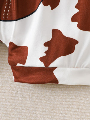 Baby bodysuit with cow print pattern, white and brown, short sleeves, casual style