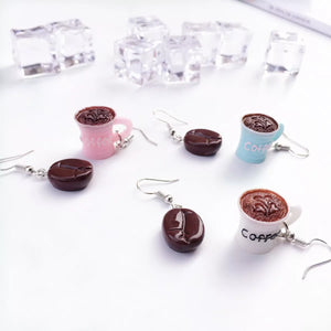 Coffee bean and cup drop earrings in ivory, pastel blue, and blush pink.