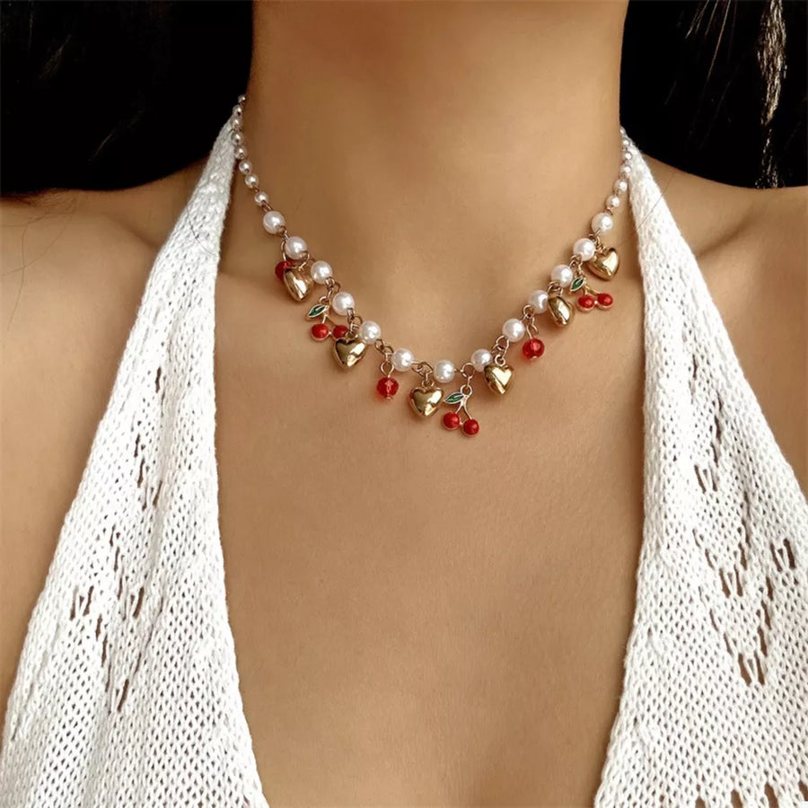 white necklace featuring pearl embellishment and motif