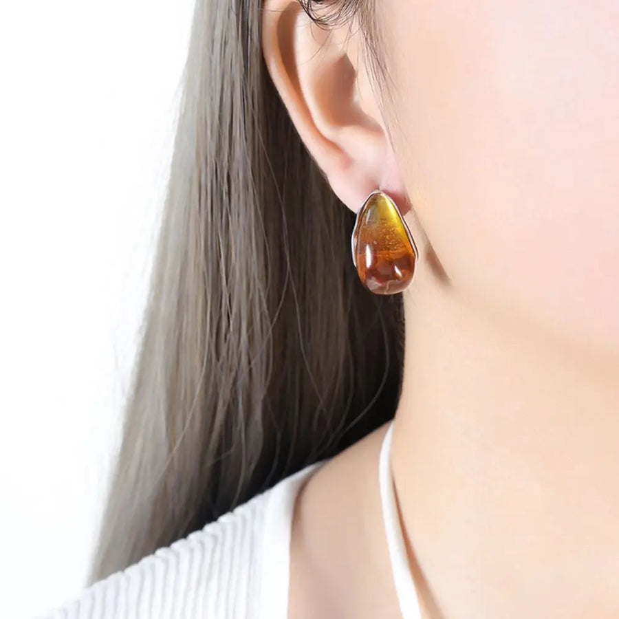 Teardrop resin stud earrings with gold trim, amber and silver tones