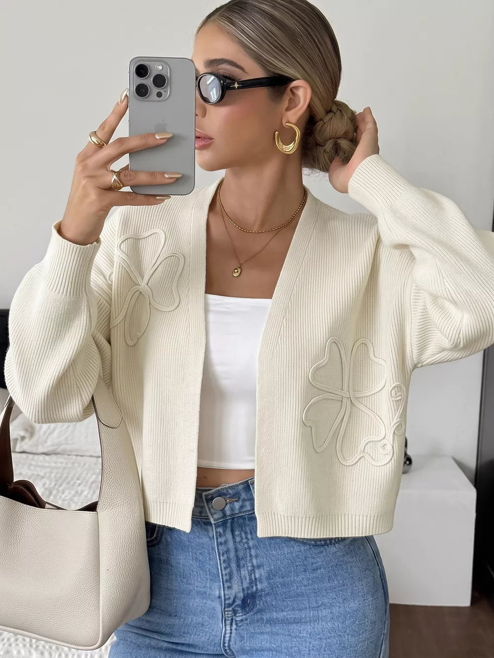 cream cardigan with four-leaf clover motif and v-neck