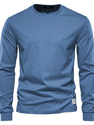 Essential crewneck long sleeve t-shirt in blue with a small logo tag detail.