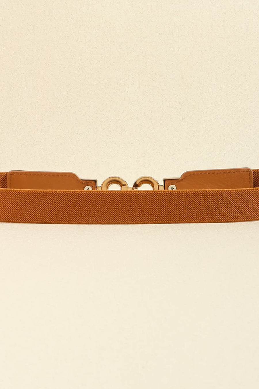 Caramel elastic belt with gold interlocking buckle detail and faux leather tab