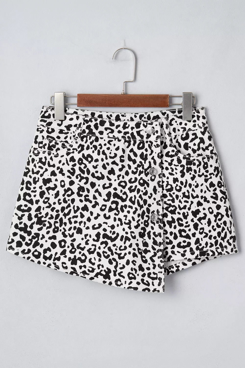 black denim shorts featuring decorative button and leopard-print