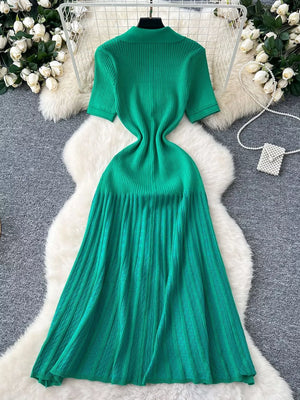 Green knit Peter Pan collar dress with short sleeves and a pleated midi skirt.