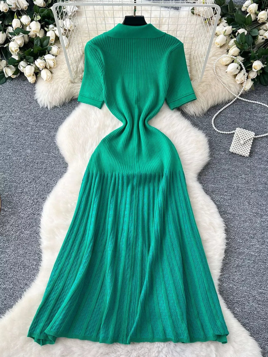 Green knit Peter Pan collar dress with short sleeves and a pleated midi skirt.