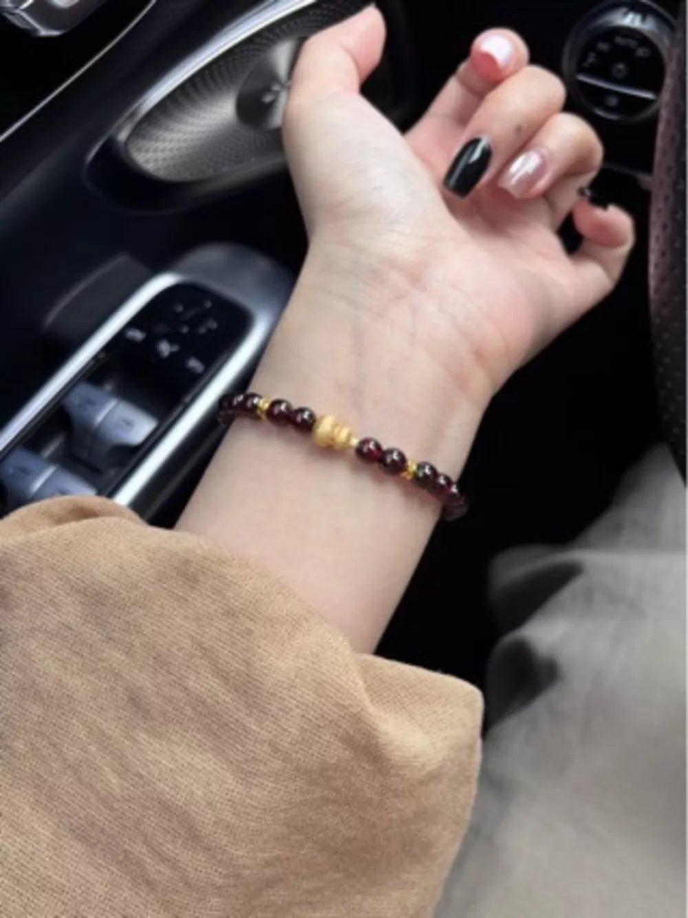 Garnet and gold gourd charm bracelet with beaded detail.