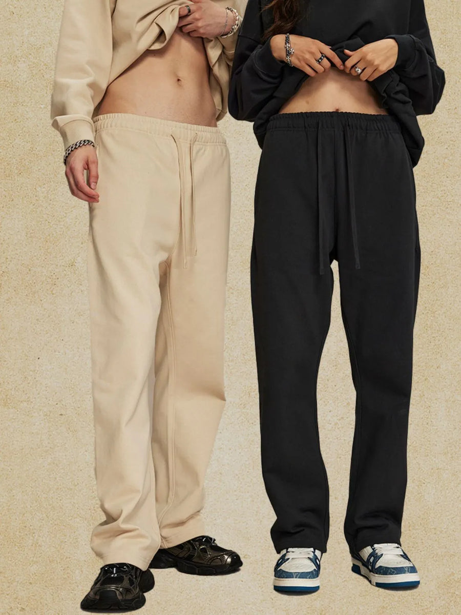Relaxed fit lounge trousers in tan and black, featuring a drawstring waist and straight leg cut.