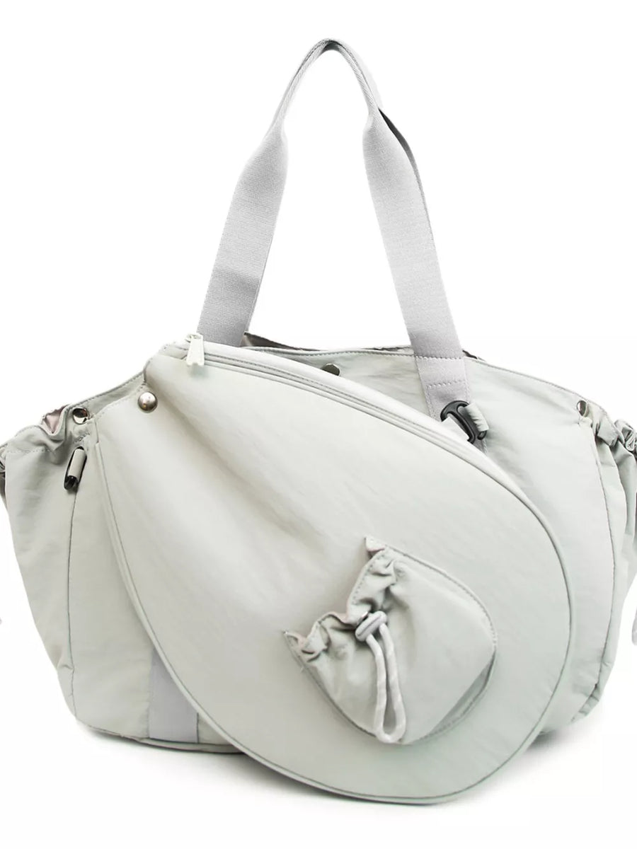 Light gray athletic nylon tote with racket holder and cinch-cord pocket.