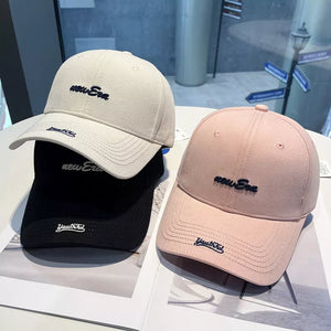 Embroidered baseball cap in pink and off-white with "new Era" and "Youthful" embroidery