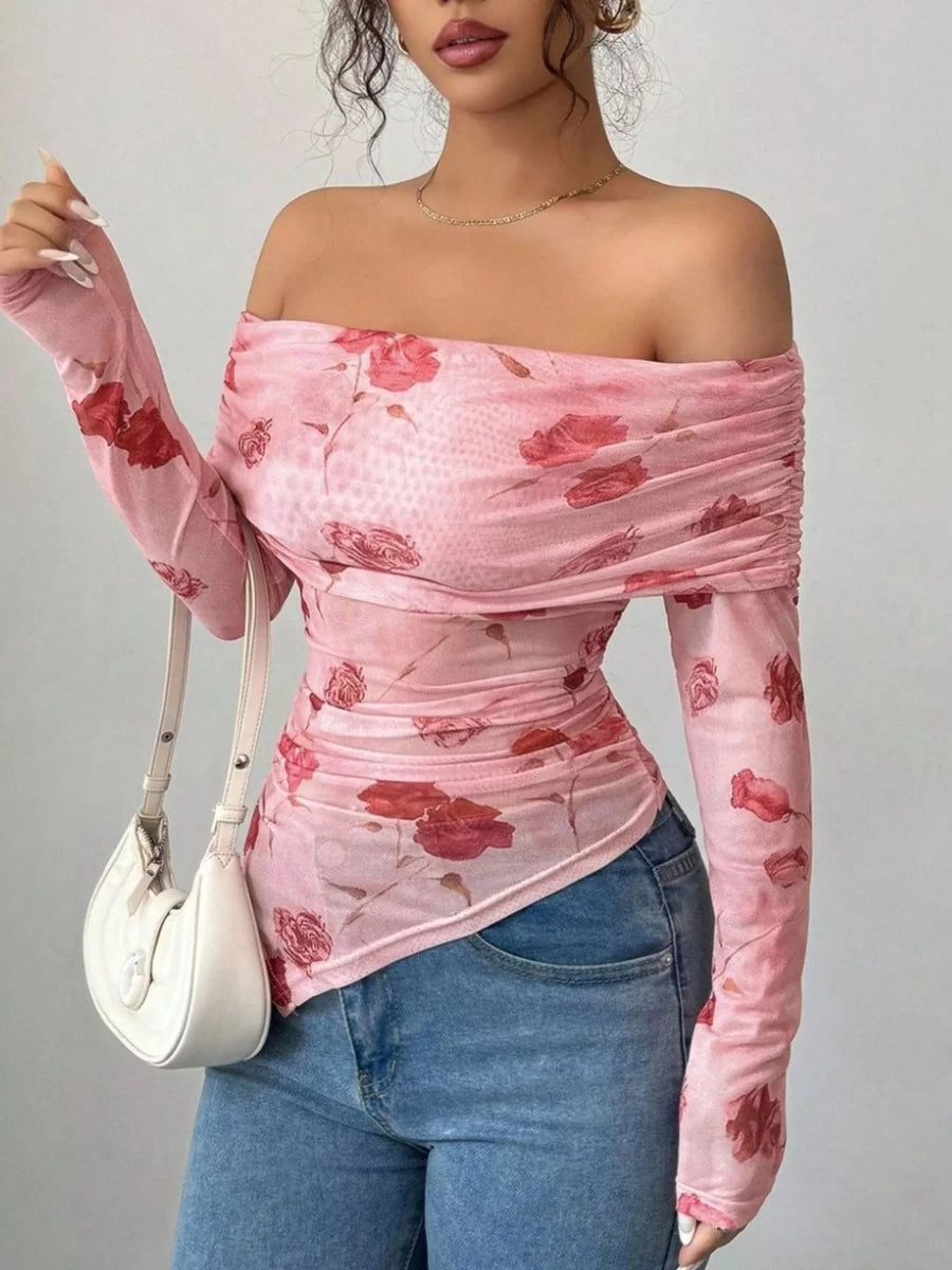 Pink ruched off-shoulder mesh top with floral print and asymmetrical hem.