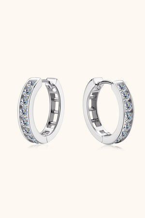 Silver moissanite channel-set hoop earrings with sparkling stones.