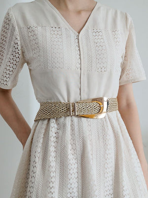 Woven raffia belt with gold-tone buckle and hardware.