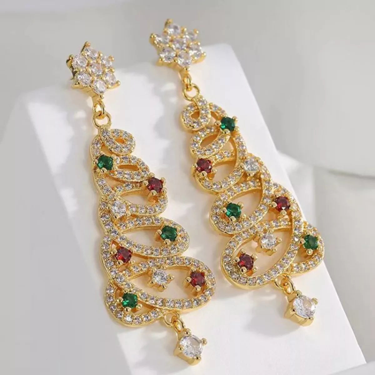 Gold Christmas tree dangle earrings with red, green, and clear crystals