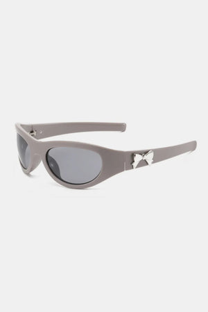 Gray sporty shield sunglasses with silver bow embellishment