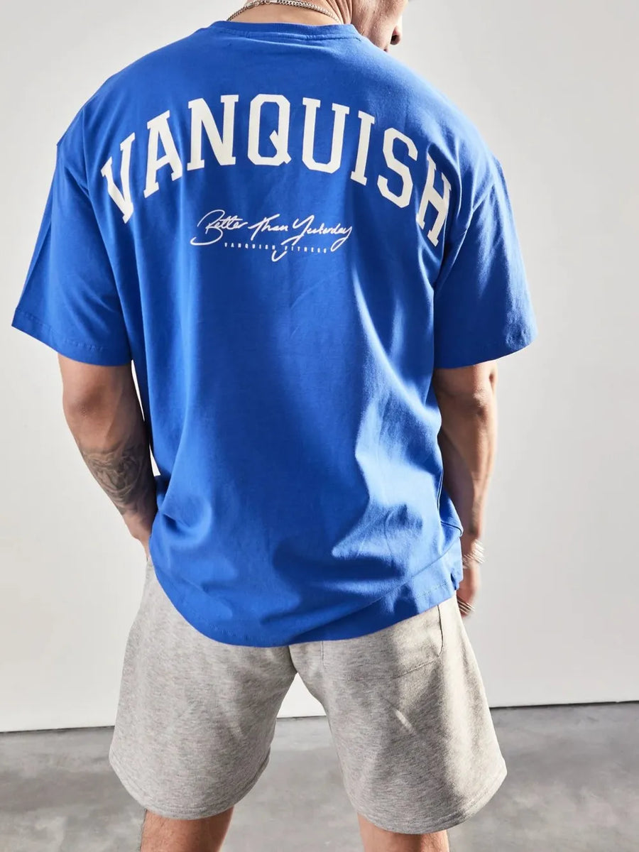 Blue oversized graphic tee with "Vanquish" back print and casual fit.