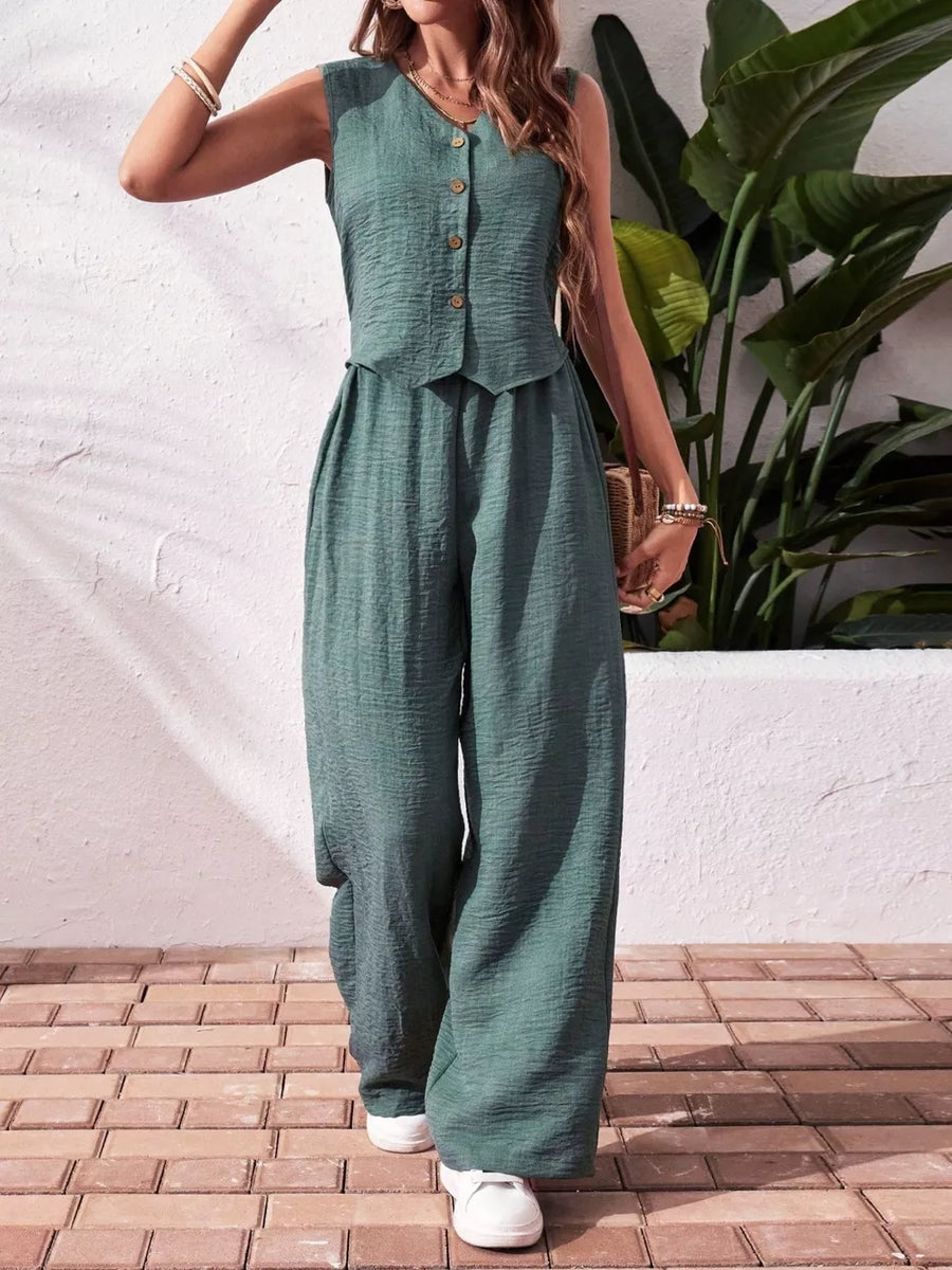 Turquoise buttoned cropped vest and wide-leg pants set with textured fabric.