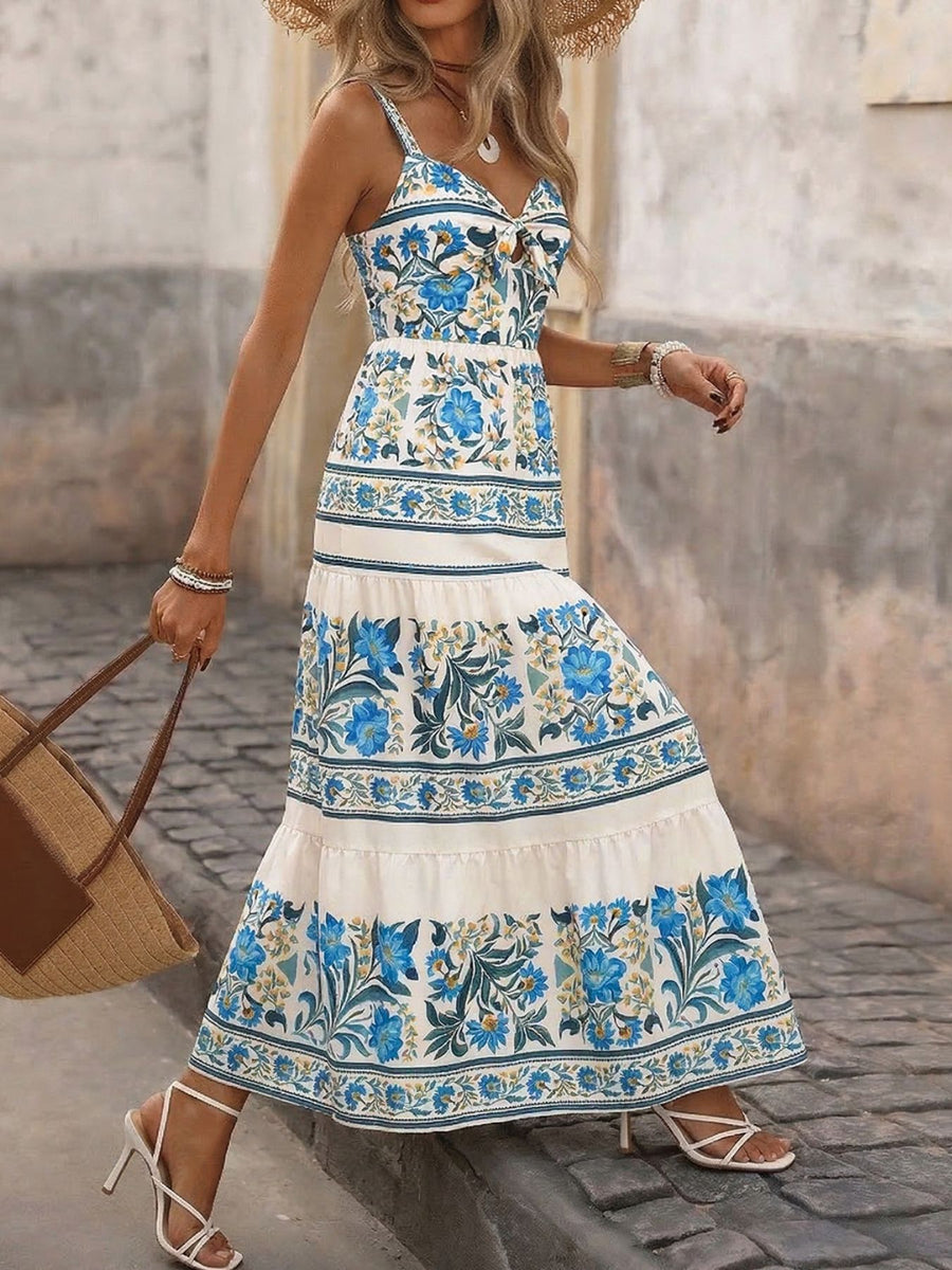 Twisted detail maxi dress with blue floral print, tie-front bodice, and tiered skirt.