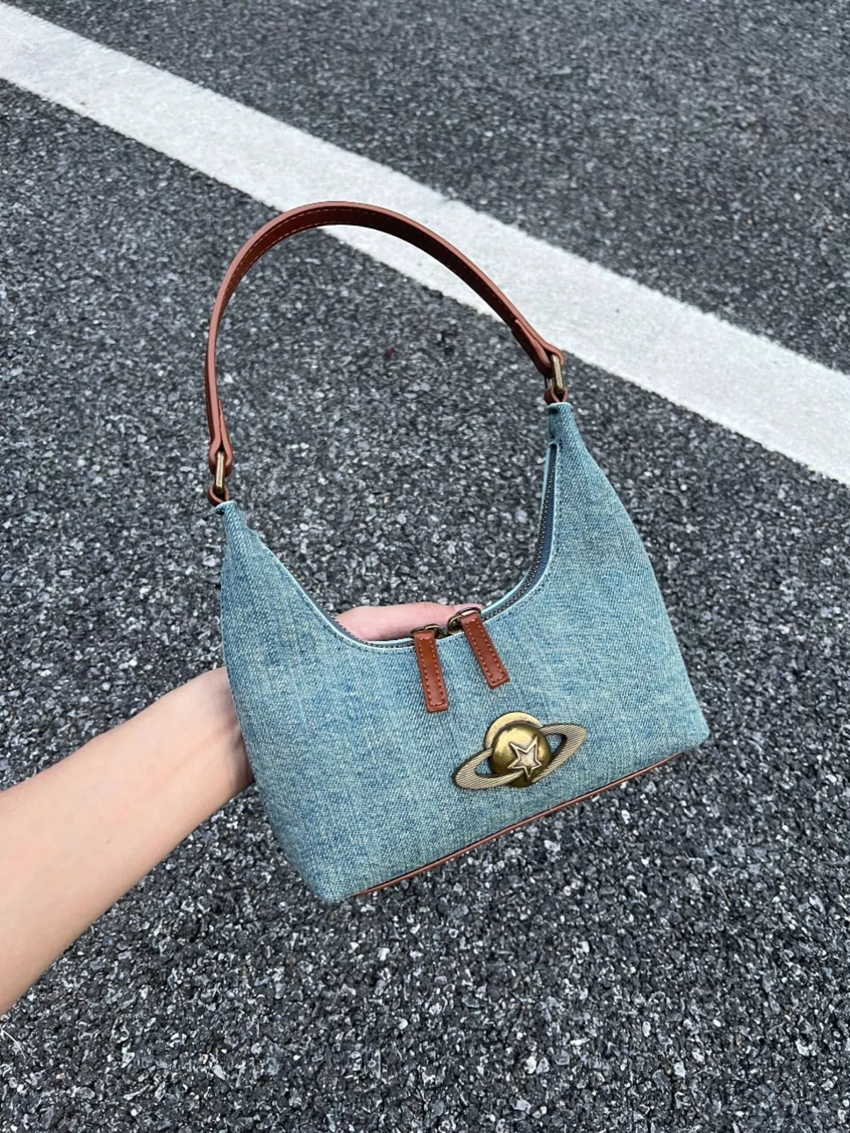 Denim shoulder bag with planet charm and brown strap