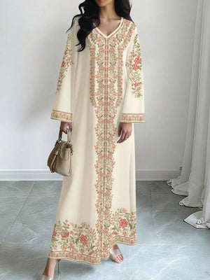 Elegant floral maxi dress in cream with embroidered details and long sleeves.