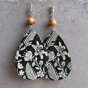 Botanical drop earrings with wood bead, featuring a white floral print on dark green.