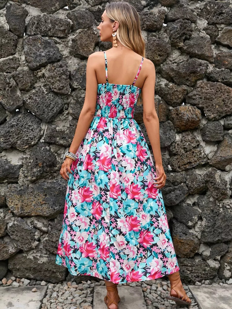 Maxi dress with floral print, smocked bodice, spaghetti straps, and flowing skirt.
