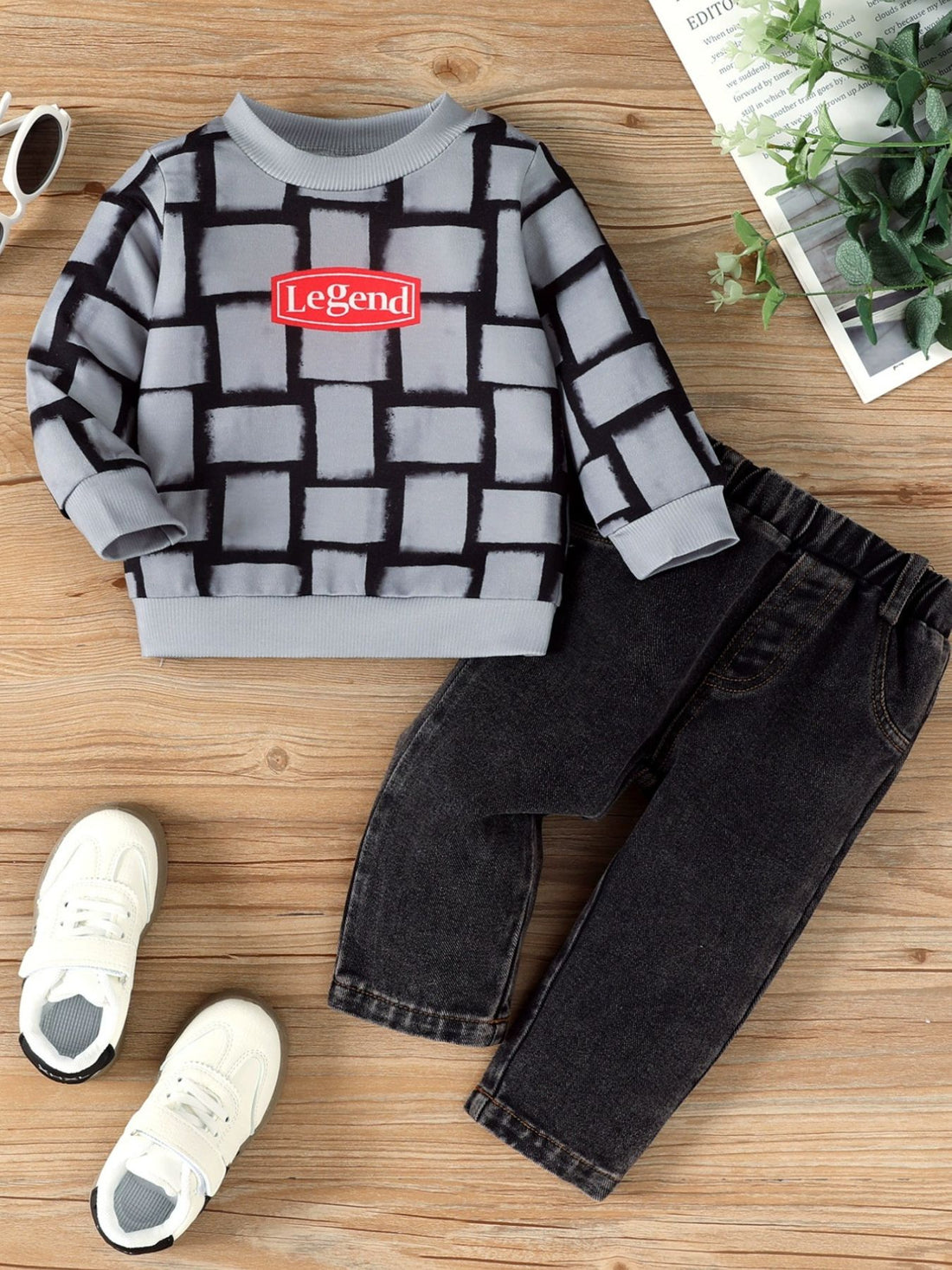 Children's grey long sleeve top with block pattern and red Legend graphic, paired with black jeans.