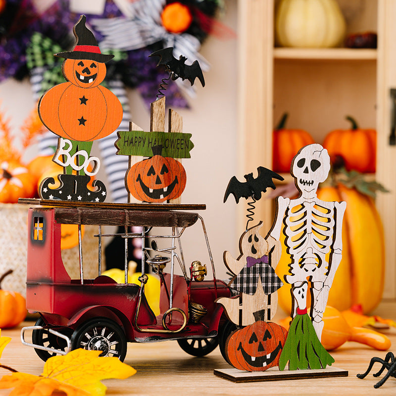 Spooky Halloween wooden scene set with a red car, pumpkins, skeleton, ghost, bats, and "Happy Halloween" sign.