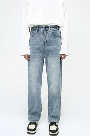 Vintage wash relaxed fit denim jeans in medium blue with button fly.