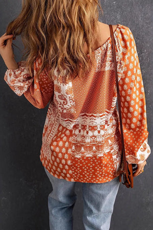 cream blouse featuring tied and paisley
