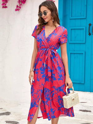 Wrap dress with red floral print on blue, V-neck, short sleeves, belted waist, midi length with slit.