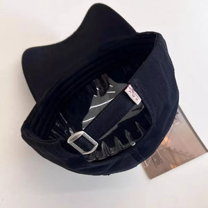 Black baseball cap with adjustable strap and metal buckle detail