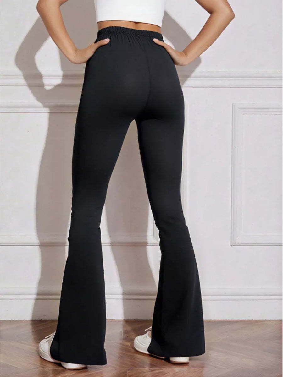 Black flared high-waist active pants with bow emblem detail.